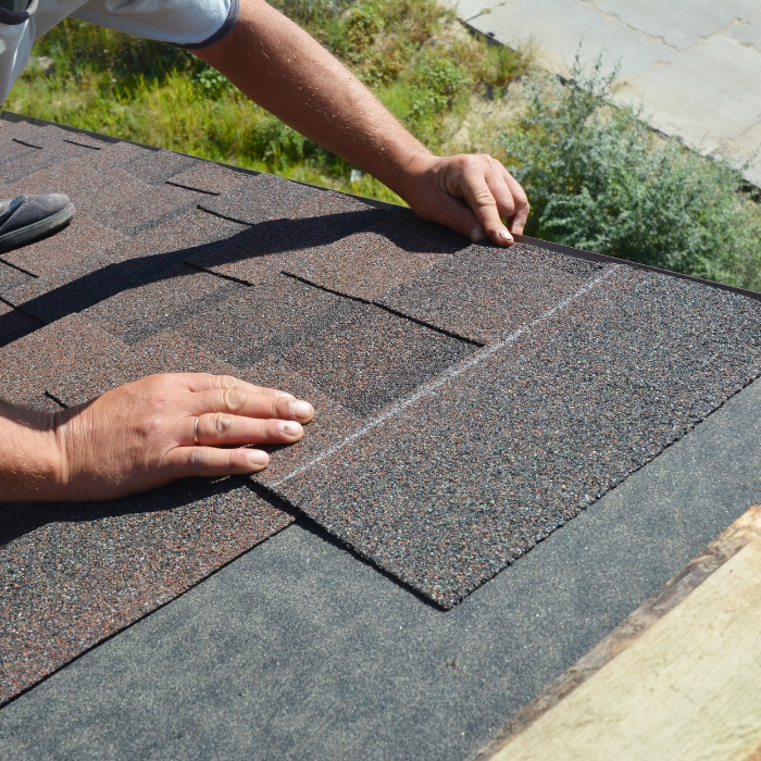 roofer hands close up replacing asphalt shingles concord nc